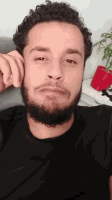 a man with a beard and curly hair is making a face