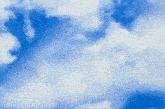 a blue sky with white clouds and a person flying in the air