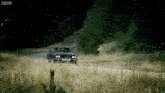 a car is driving down a dirt road with bbc written on the bottom of the screen