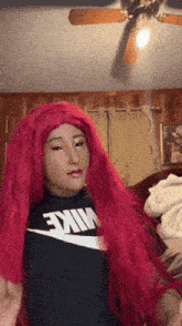 a girl wearing a red wig and a black nike shirt