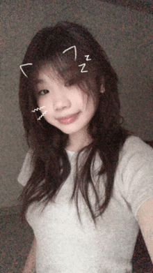 a girl taking a selfie with a cat ear on her head and a zzz sticker on her face
