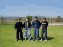 a man wearing a shirt that says boss stands in a grassy field
