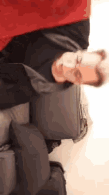 a man is laying on his back next to a suitcase and a pillow .