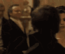 a man and a woman are dancing together and looking at each other in a room .