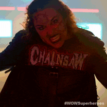 a woman is wearing a chainsaw t-shirt and a wow superheroes logo