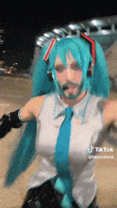 a woman in a hatsune miku costume with a beard