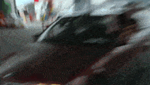 a blurry picture of a car driving down a road