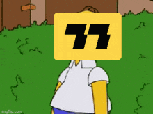 homer simpson is standing in the grass with a yellow box with the number 77 on it