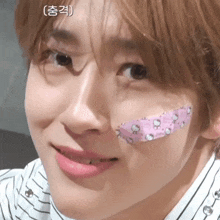 a close up of a person with a hello kitty patch on their face