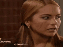 a close up of a woman 's face with the hashtag lialmeida05 on the bottom