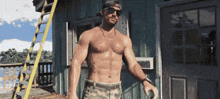 a shirtless man wearing sunglasses and a baseball cap stands in front of a building