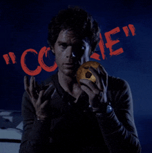 a man is holding a cookie in front of the word " cookie "