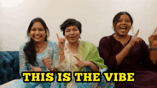 three women sitting on a couch with the words " this is the vibe " on the bottom