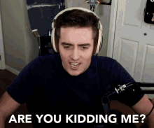 a man wearing headphones is asking if he is kidding