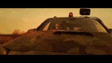 a man driving a car with a megaphone on top of it