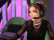 a woman wearing headphones and a choker is smiling