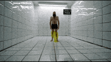 a man stands in a room with a sign that says level 6 pissa