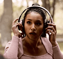 a woman wearing headphones with a surprised look on her face