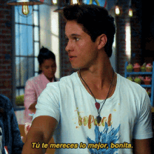 a man wearing a t-shirt that says tropical is talking to someone