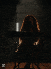 a woman with red hair is playing a yamaha keyboard with her eyes closed