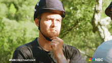 a man wearing a helmet with a nbc destination x logo in the corner