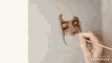 a person is painting a woman 's face with a brush and the words made in animatica are visible in the corner