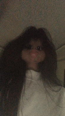 a woman with long hair is wearing a white sweater