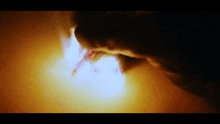 a close up of a person 's face with a flame coming out of it