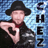 a man in a hat making a heart shape with his hands in front of the word chen