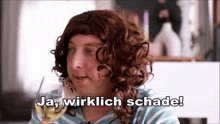 a man in a wig is holding a glass of wine and says ja wirklich schade