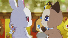 a cat wearing a crown stands next to a white bunny