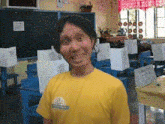 a man wearing a yellow shirt that says ' a ' on it