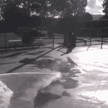 a skateboarder is doing a trick on a ramp in a park .