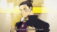 a man in a bun is standing in front of a yellow wall and talking about trees .