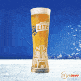 a glass of castle lite beer with a castle design on it