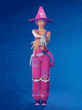a woman wearing a pink cone hat and pink overalls