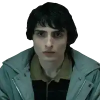 a close up of a young man 's face wearing a grey jacket