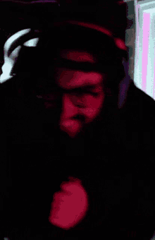 a man wearing headphones and a storm trooper mask looks at the camera