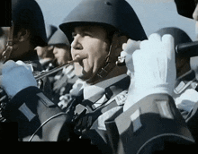 a man in a black helmet is playing a trumpet in a band