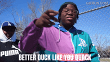 a man wearing a puma jacket is pointing at something