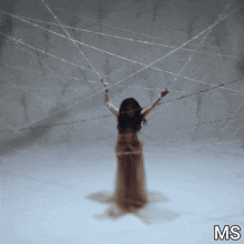 a woman in a white dress is surrounded by spider webs and the letters ms are on the bottom