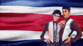 two men standing in front of an american flag