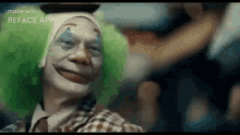 a man in a clown costume is smiling and looking at the camera while sitting on a bus .