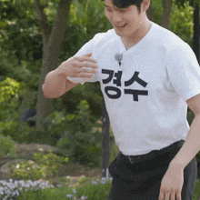 a man wearing a white t-shirt with korean writing on it