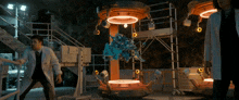 a man in a lab coat stands in front of a machine that looks like a spaceship
