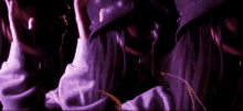 a woman wearing a purple hat and a purple sweater