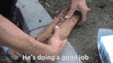 a person is holding a piece of wood with the words he 's doing a good job written on it