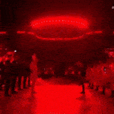 a group of people are dancing on a red stage .