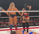 two women are wrestling in a ring and one has a tattoo on her butt that says ' i love you '