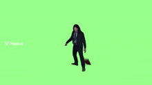 a woman in a suit and tie is dancing in front of a green screen